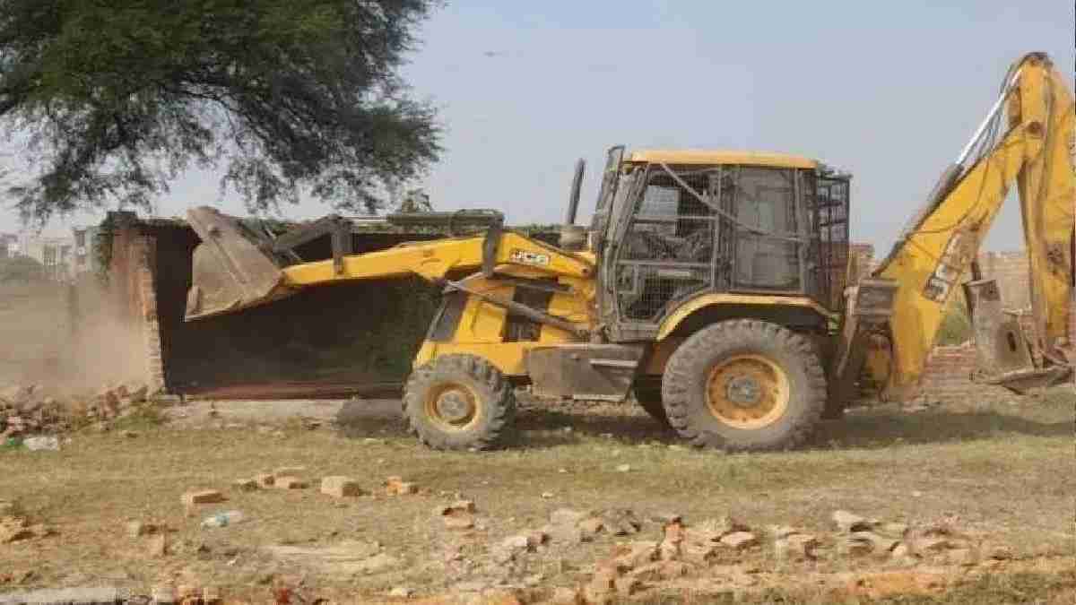 Bulldozer demolishing illegal construction on government land